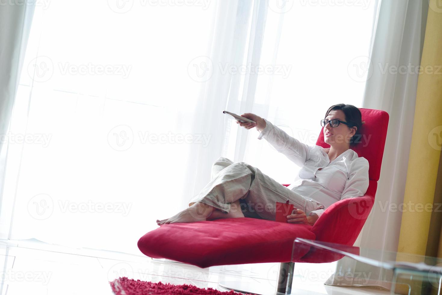 young woman watching tv at home photo