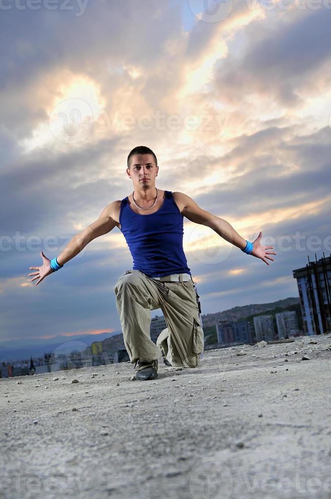 young man jumping in air outdoor at night ready to party photo