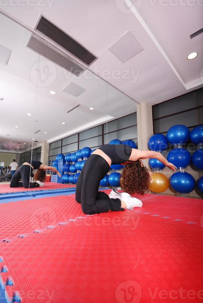 pretty girl warming up in fitness studio photo