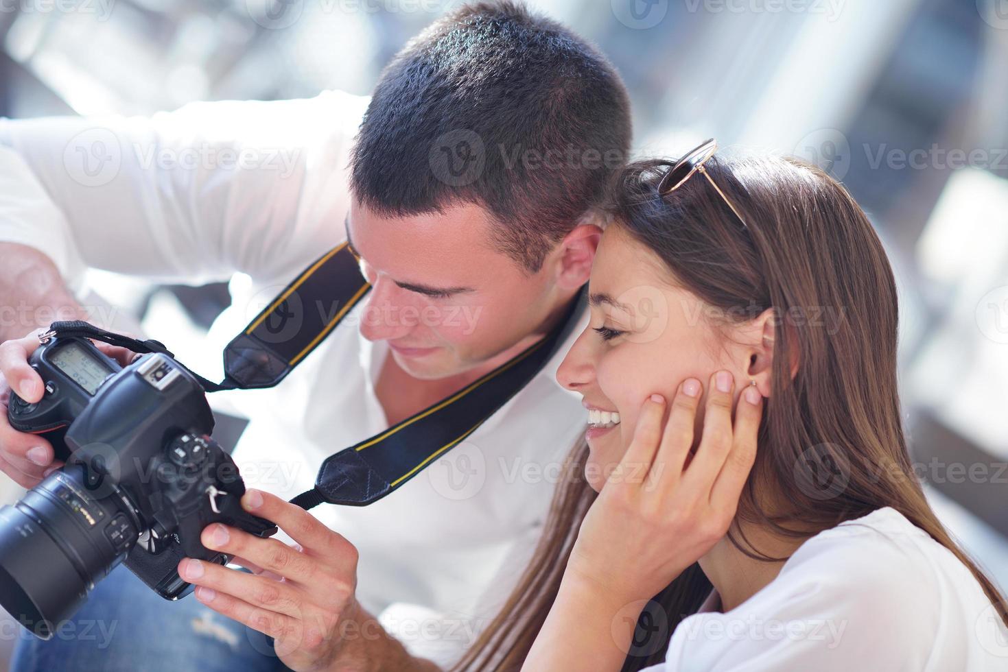 couple looking photos on camera