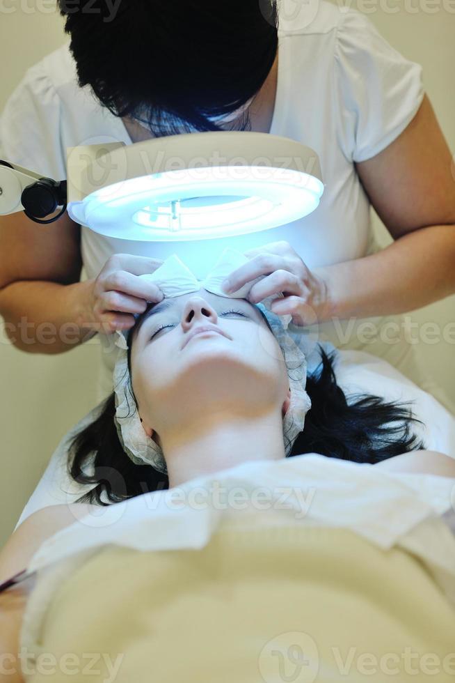 woman with facial mask in cosmetic studio photo