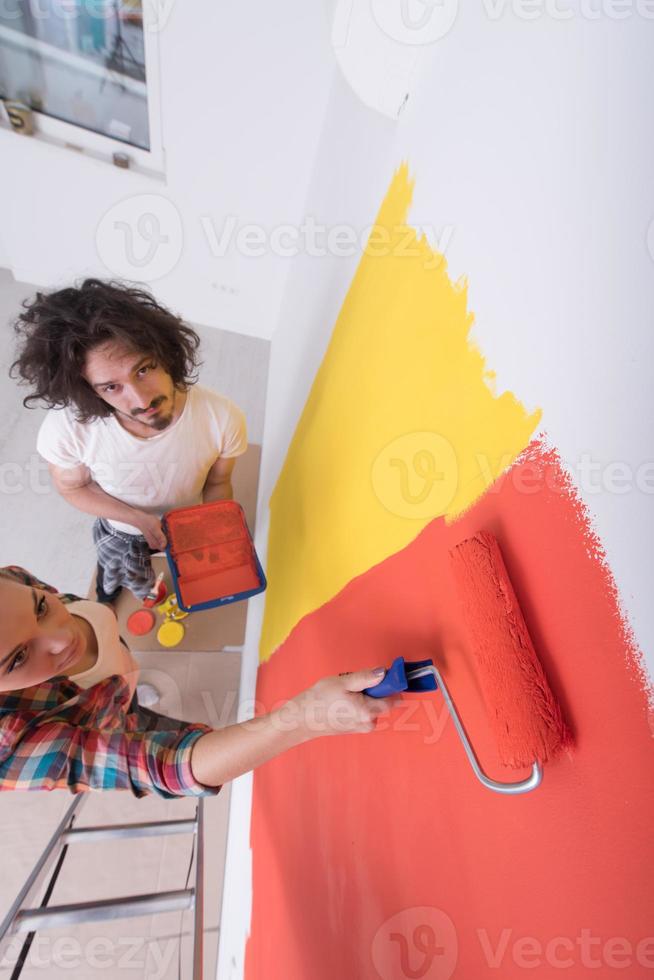 couple painting interior wall photo