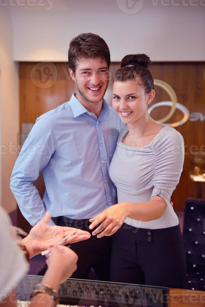 happy young couple in jewelry store photo