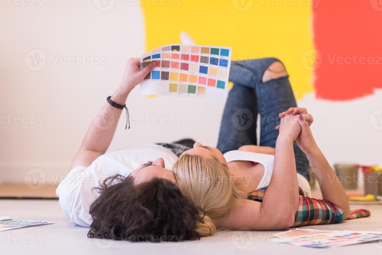 Happy young couple relaxing after painting photo
