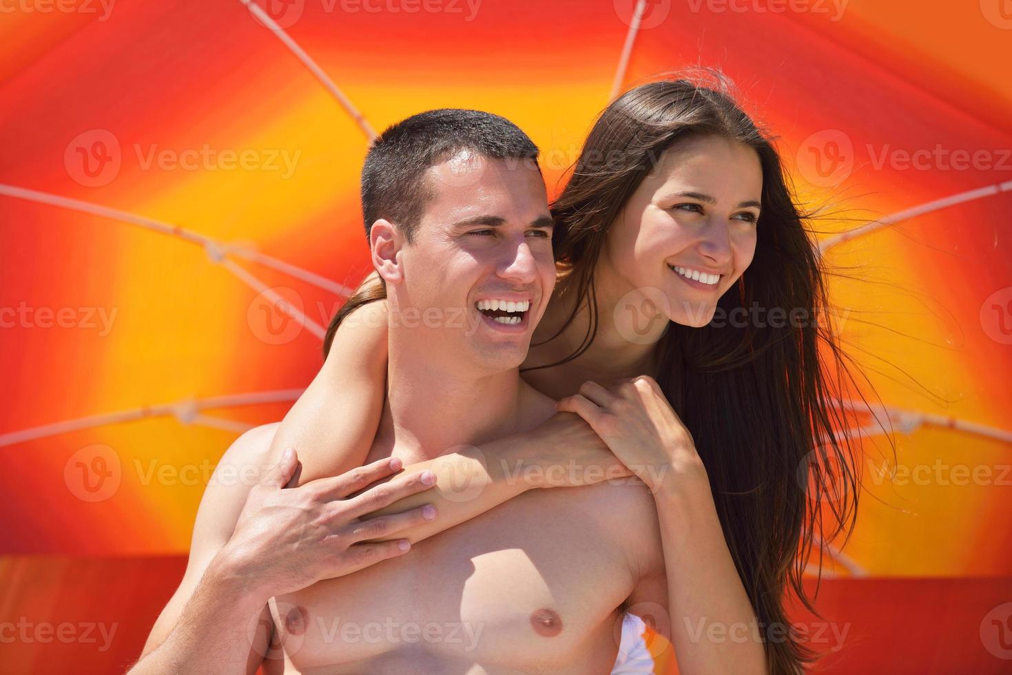 happy young couple have fun on beach photo