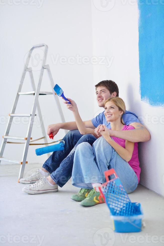 happy young cople relaxing after painting in new home photo