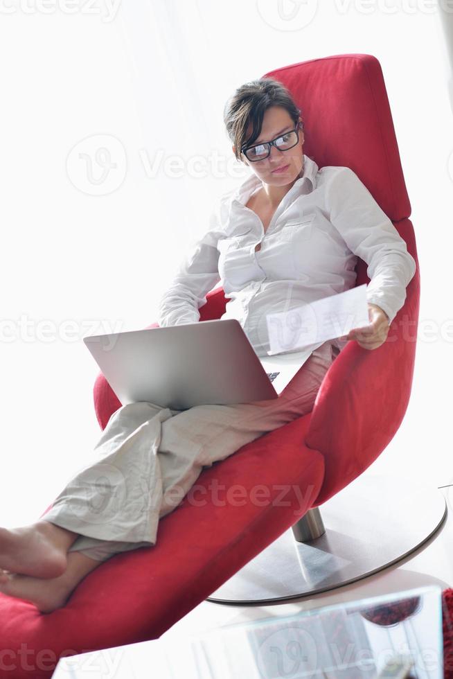 woman using a laptop computer at home photo