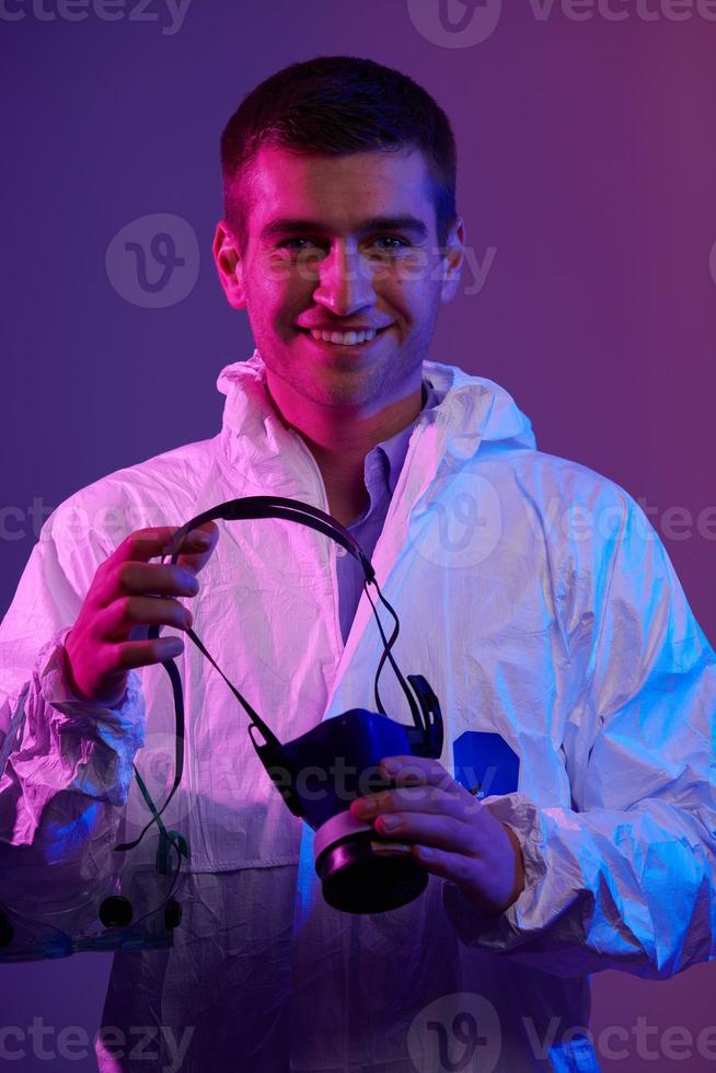Doctor wearing protective biological suit and mask due to coronavirus photo