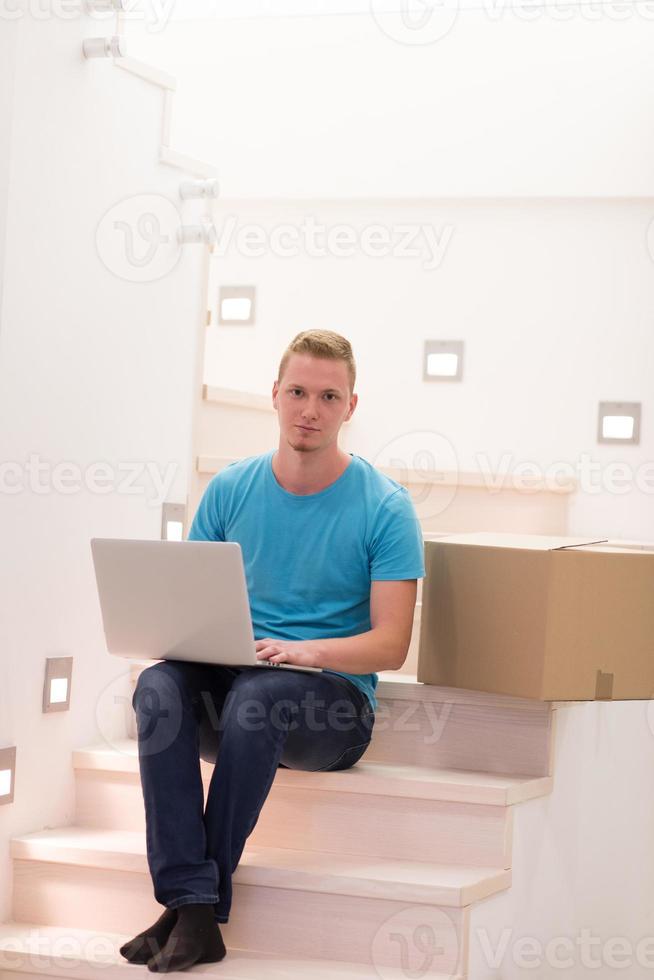 young man sitting in stairway at home photo