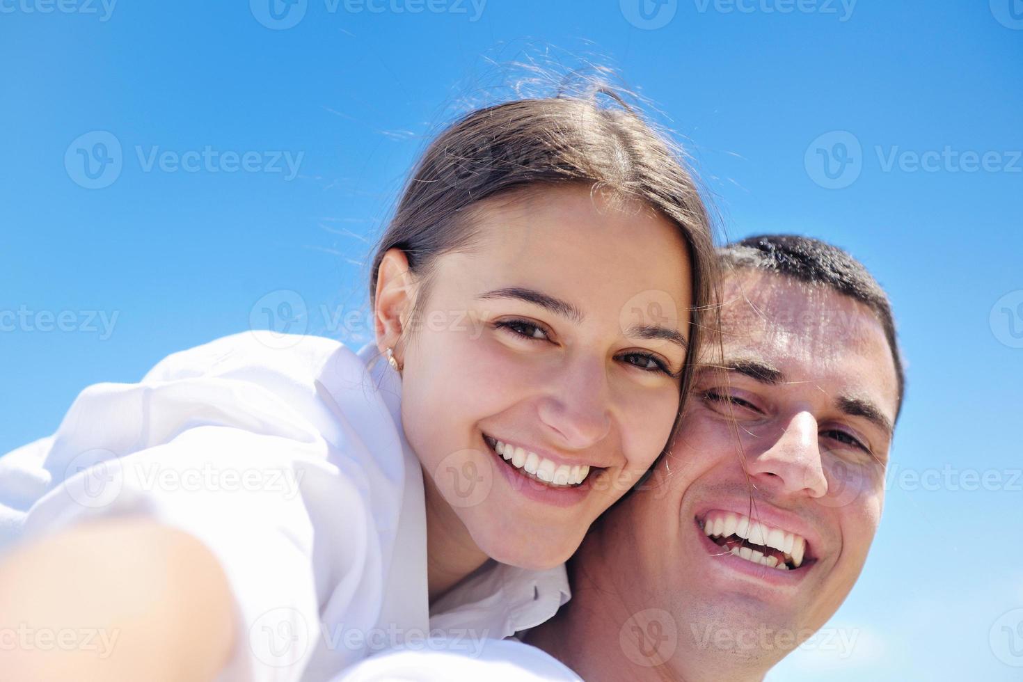 happy couple have fun on the beach photo