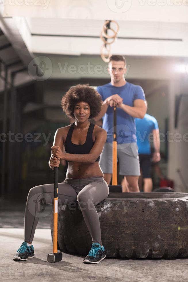 multiethnic couple after workout with hammer photo