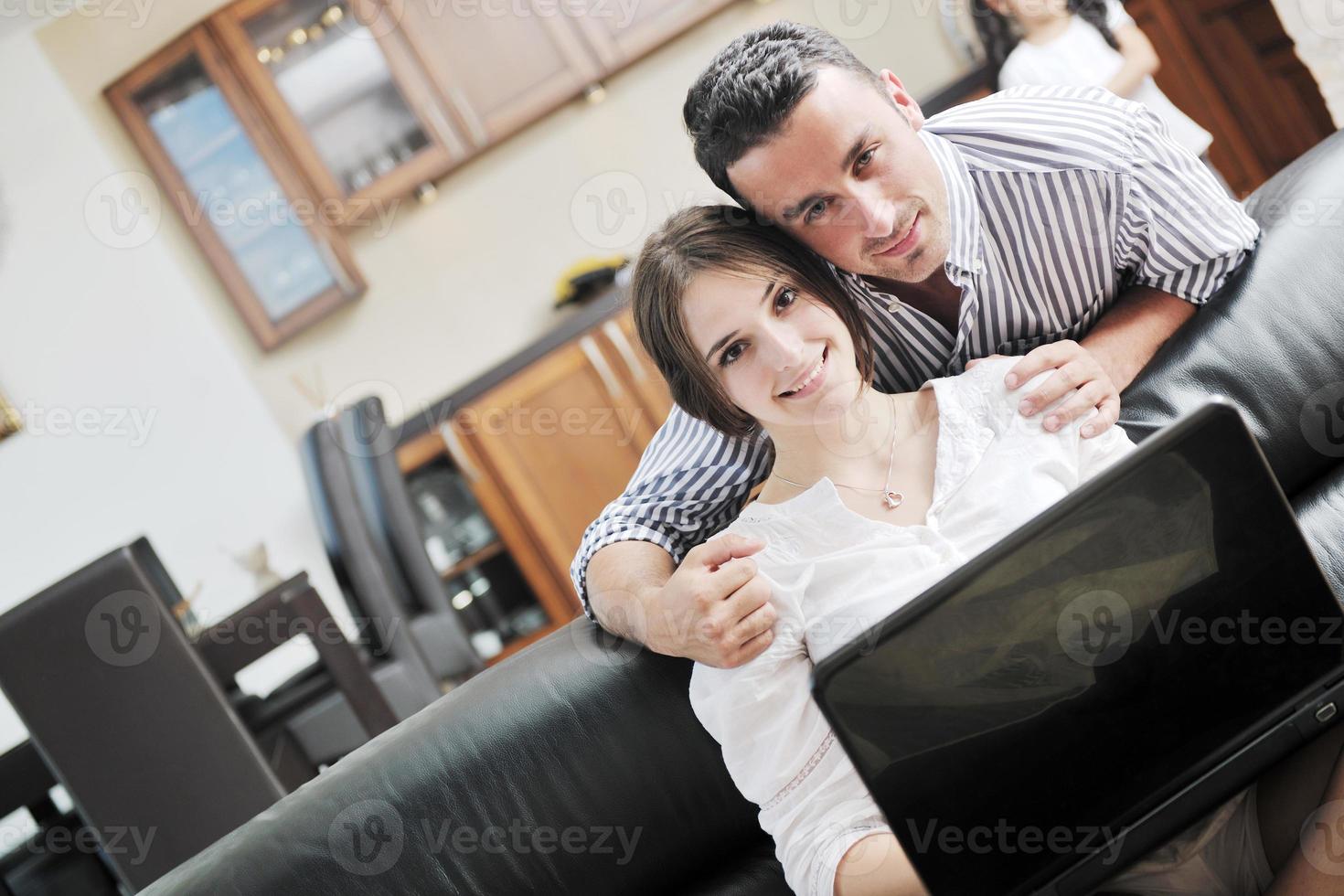 joyful couple relax and work on laptop computer at modern home photo