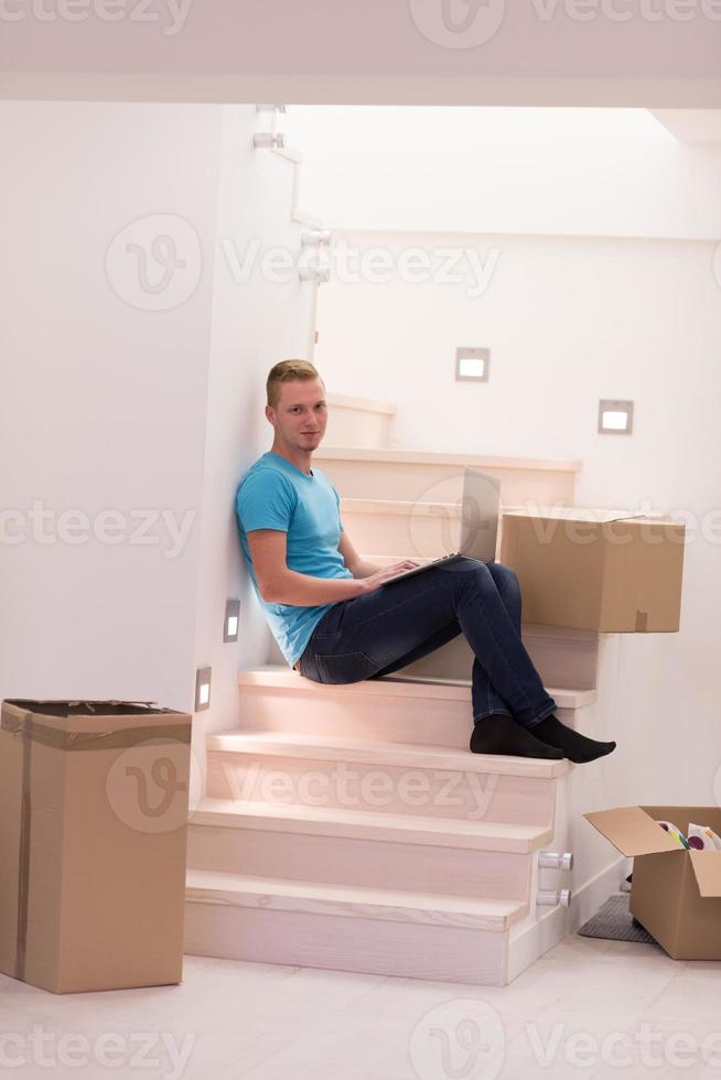 young man sitting in stairway at home photo