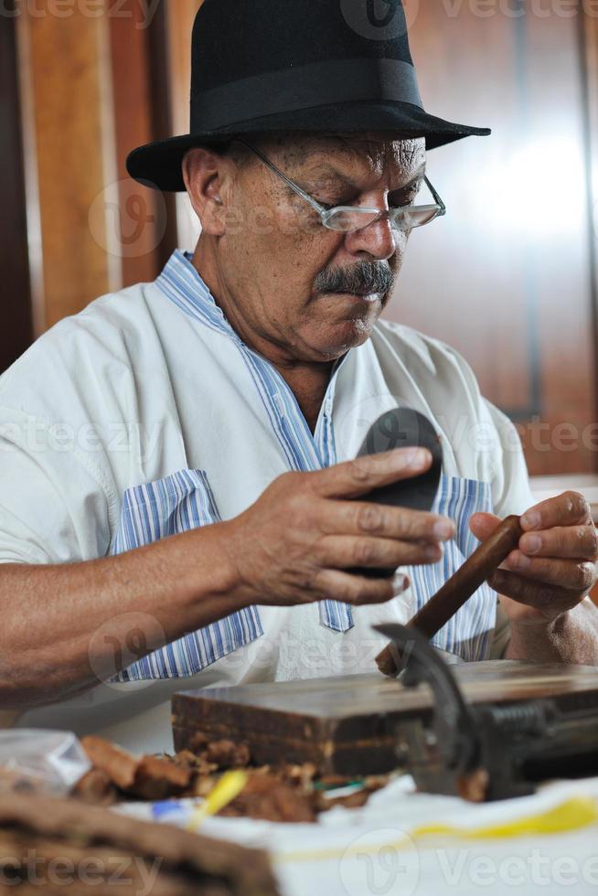 man making luxury handmade cuban cigare photo
