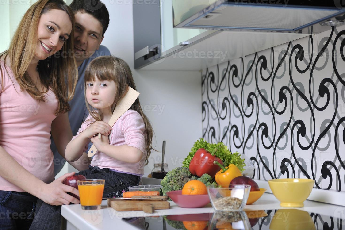 happy young family in kitchen photo