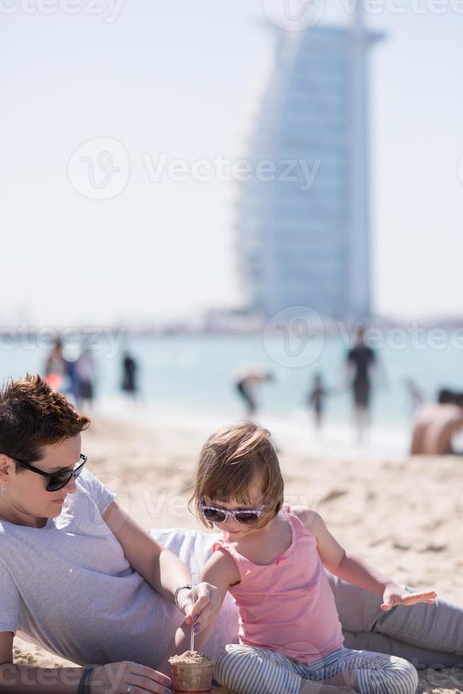 Mom and daughter on the beach photo