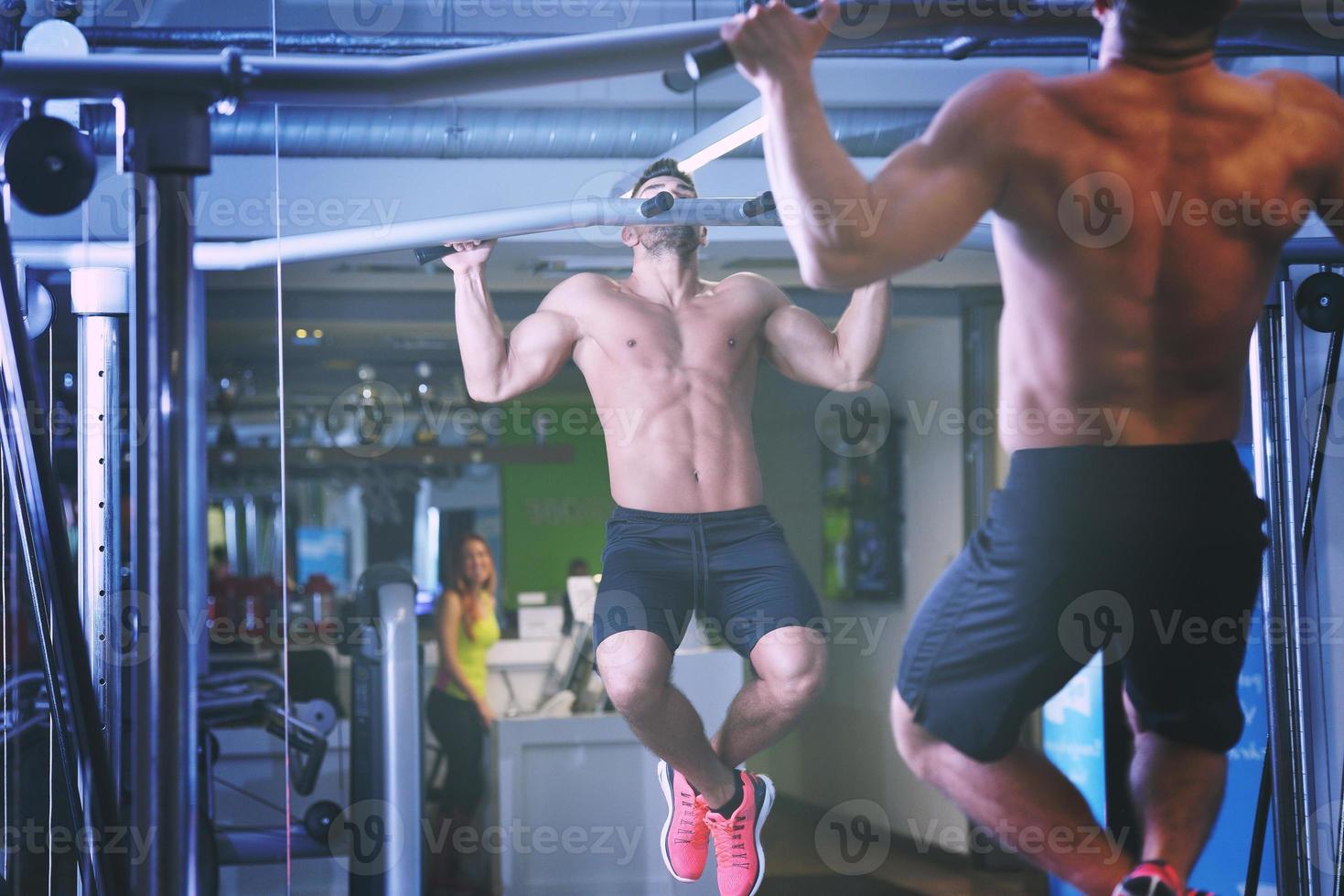 handsome man exercising at the gym photo