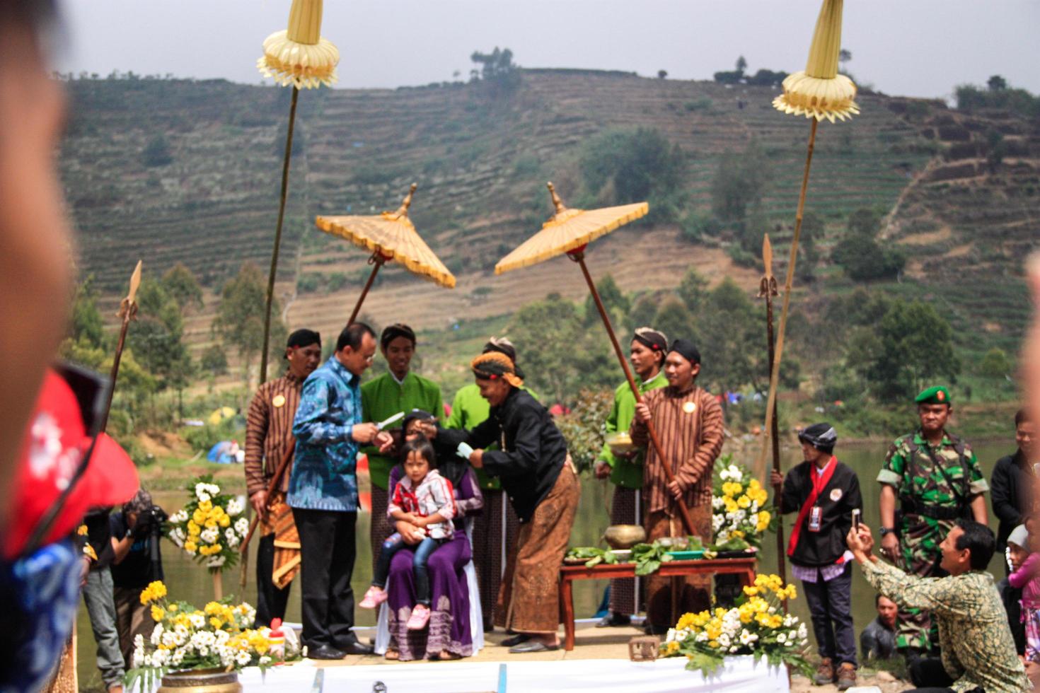 Dieng, Indonesia - August 1, 2015. Dieng Culture Festival, Tourists follow the dreadlocks procession during the Dieng Culture Festival event at Dieng, Banjarnegara district, Central Java photo