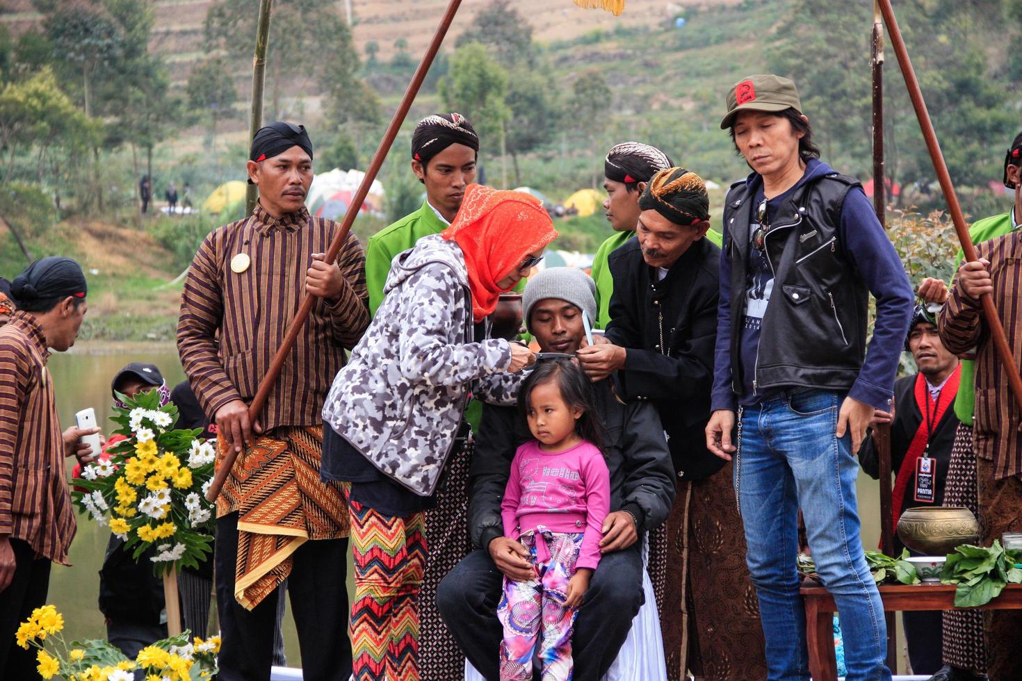 Dieng, Indonesia - August 1, 2015. Dieng Culture Festival, Tourists follow the dreadlocks procession during the Dieng Culture Festival event at Dieng, Banjarnegara district, Central Java photo