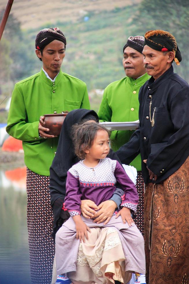 Dieng, Indonesia - August 1, 2015. Dieng Culture Festival, Tourists follow the dreadlocks procession during the Dieng Culture Festival event at Dieng, Banjarnegara district, Central Java photo