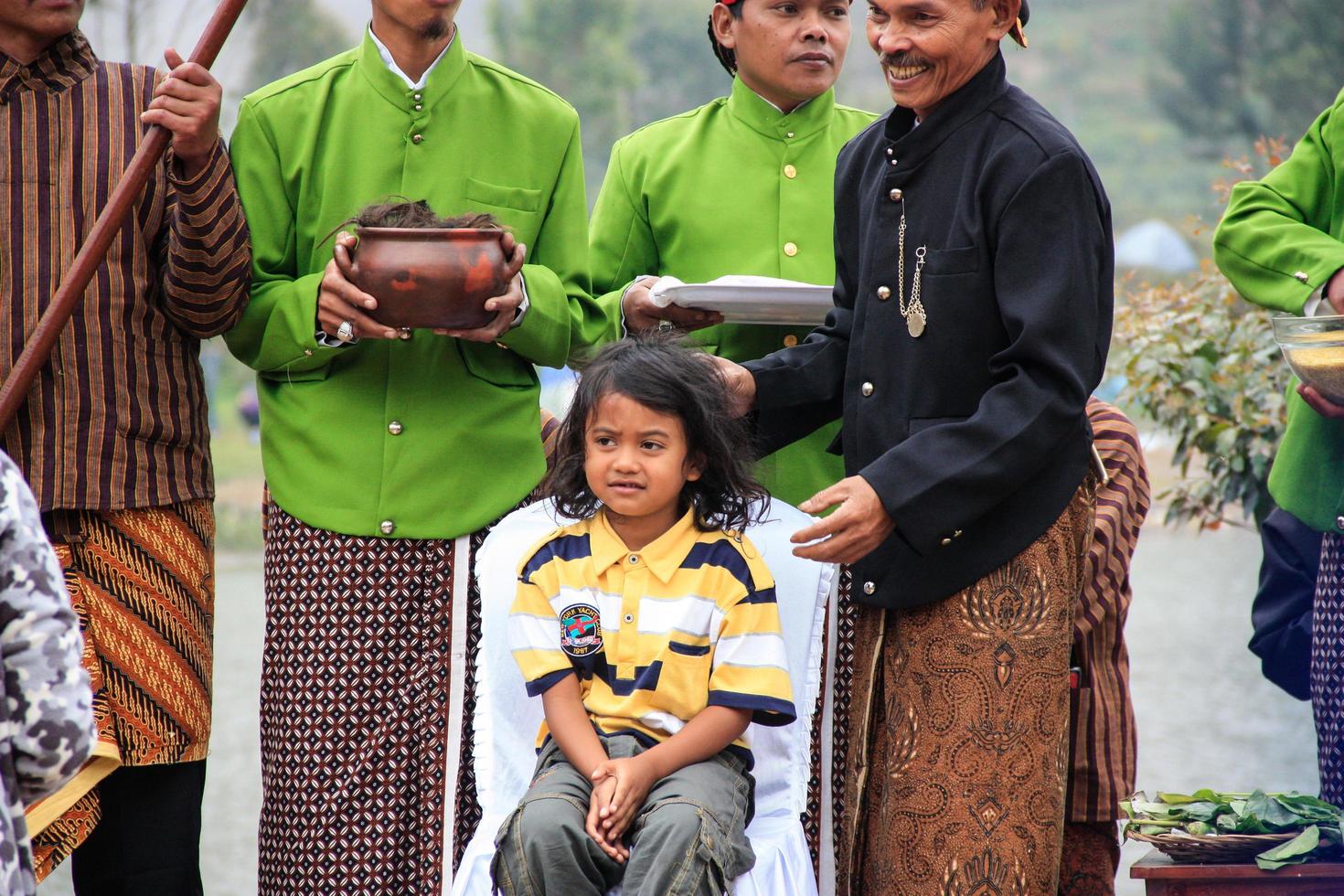 Dieng, Indonesia - August 1, 2015. Dieng Culture Festival, Tourists follow the dreadlocks procession during the Dieng Culture Festival event at Dieng, Banjarnegara district, Central Java photo