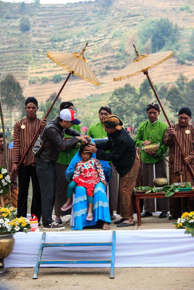 Dieng, Indonesia - August 1, 2015. Dieng Culture Festival, Tourists follow the dreadlocks procession during the Dieng Culture Festival event at Dieng, Banjarnegara district, Central Java photo