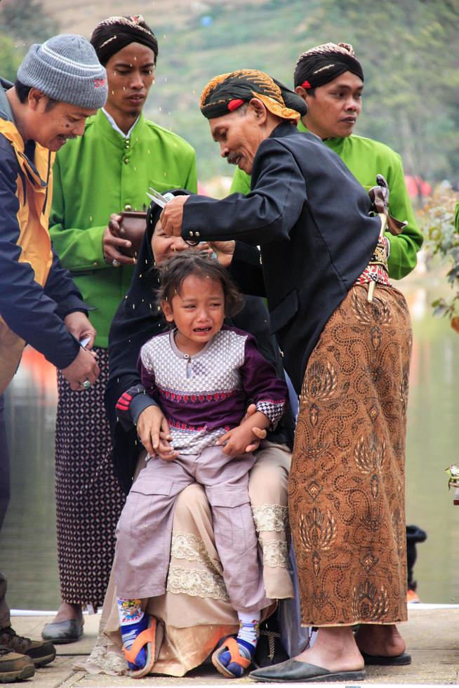 Dieng, Indonesia - August 1, 2015. Dieng Culture Festival, Tourists follow the dreadlocks procession during the Dieng Culture Festival event at Dieng, Banjarnegara district, Central Java photo