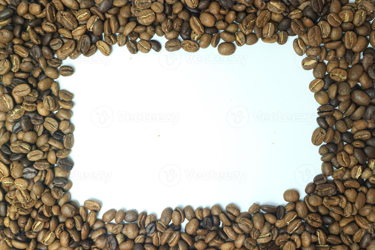 Frame made from roasted coffee beans over white background with room for text or image photo