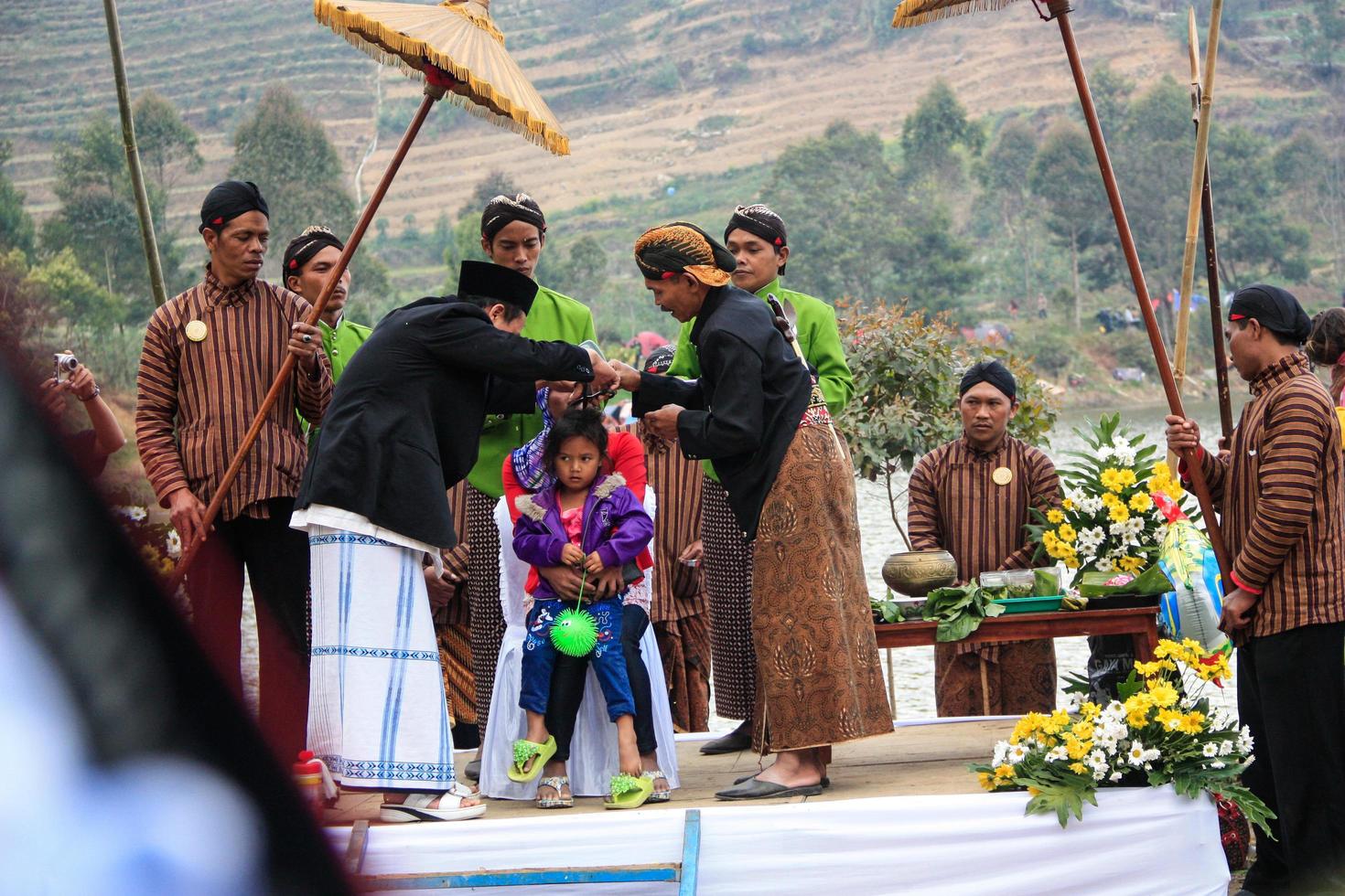 Dieng, Indonesia - August 1, 2015. Dieng Culture Festival, Tourists follow the dreadlocks procession during the Dieng Culture Festival event at Dieng, Banjarnegara district, Central Java photo