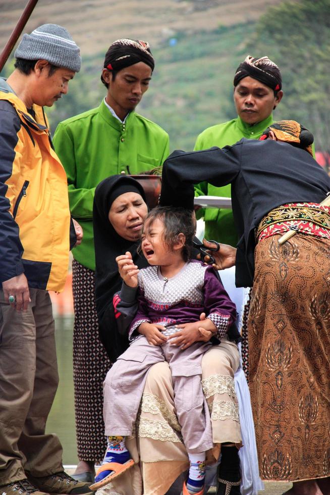 Dieng, Indonesia - August 1, 2015. Dieng Culture Festival, Tourists follow the dreadlocks procession during the Dieng Culture Festival event at Dieng, Banjarnegara district, Central Java photo