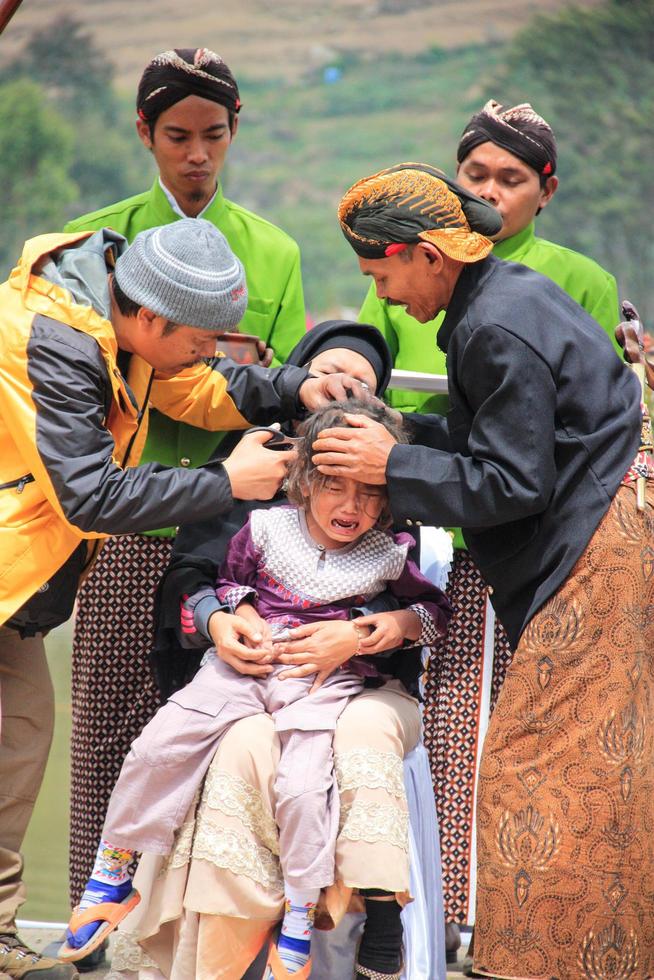 Dieng, Indonesia - August 1, 2015. Dieng Culture Festival, Tourists follow the dreadlocks procession during the Dieng Culture Festival event at Dieng, Banjarnegara district, Central Java photo