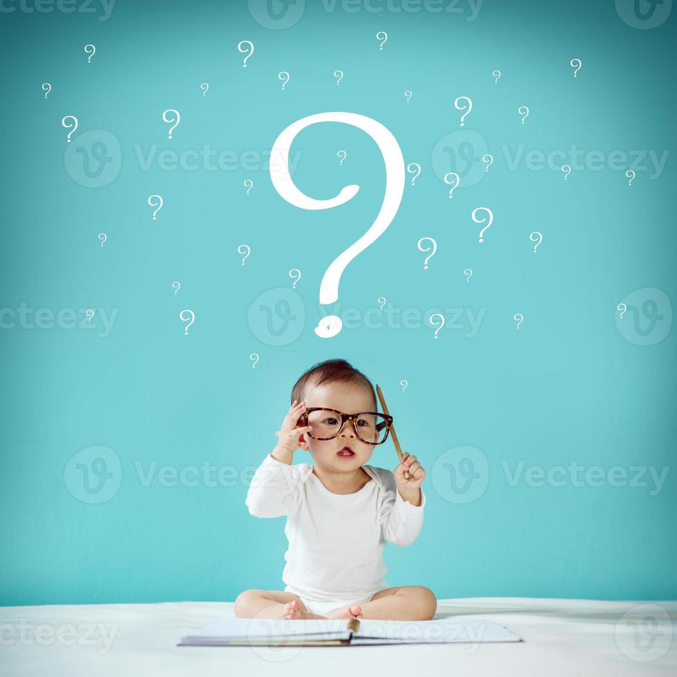 Little baby and blackboard with Question Mark on background, School concept photo