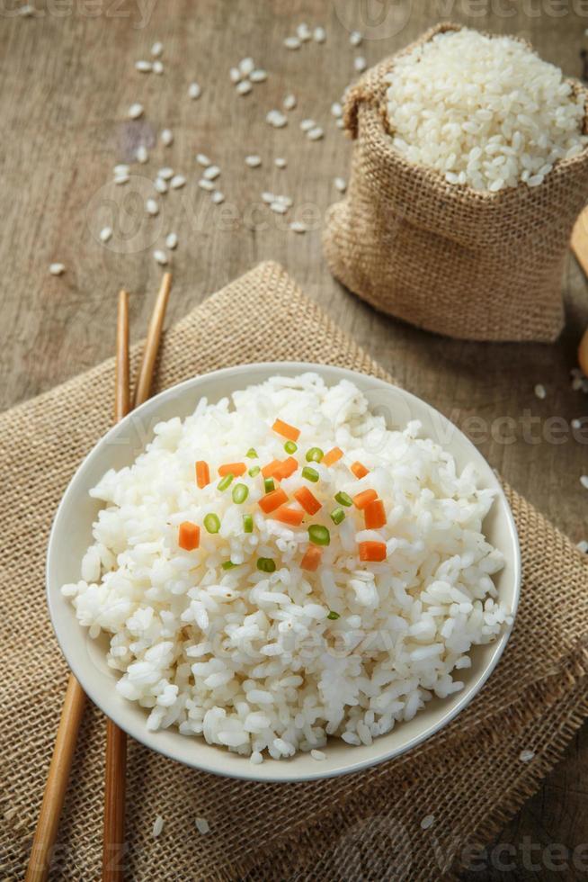 Steamed rice close-up with chopsticks on burlap photo