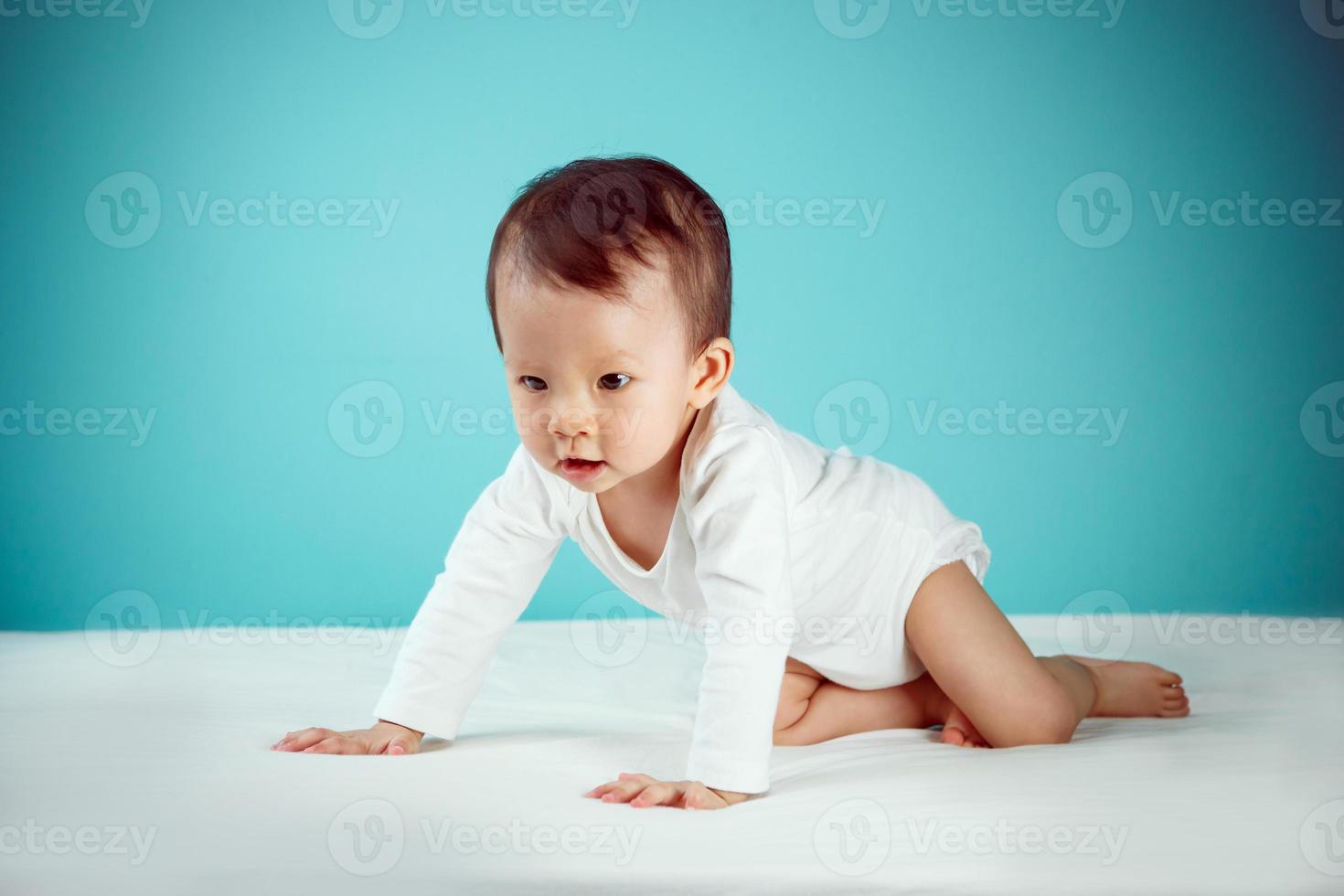 Side view of pretty crawling newborn photo