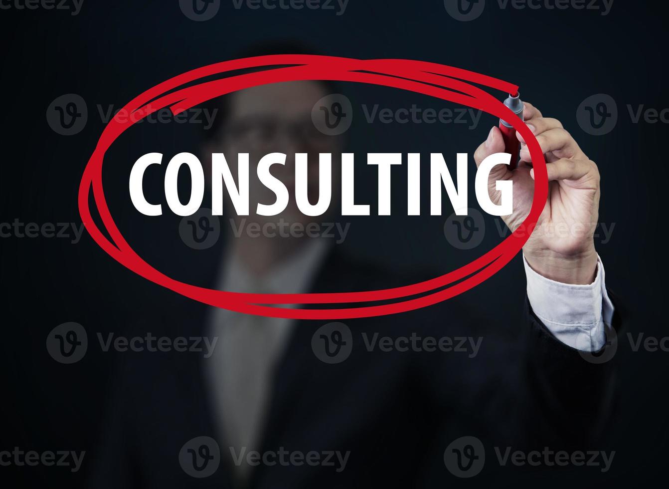 Businessman hand writing Consulting with red marker on transparent board, new business concept, studio shot photo