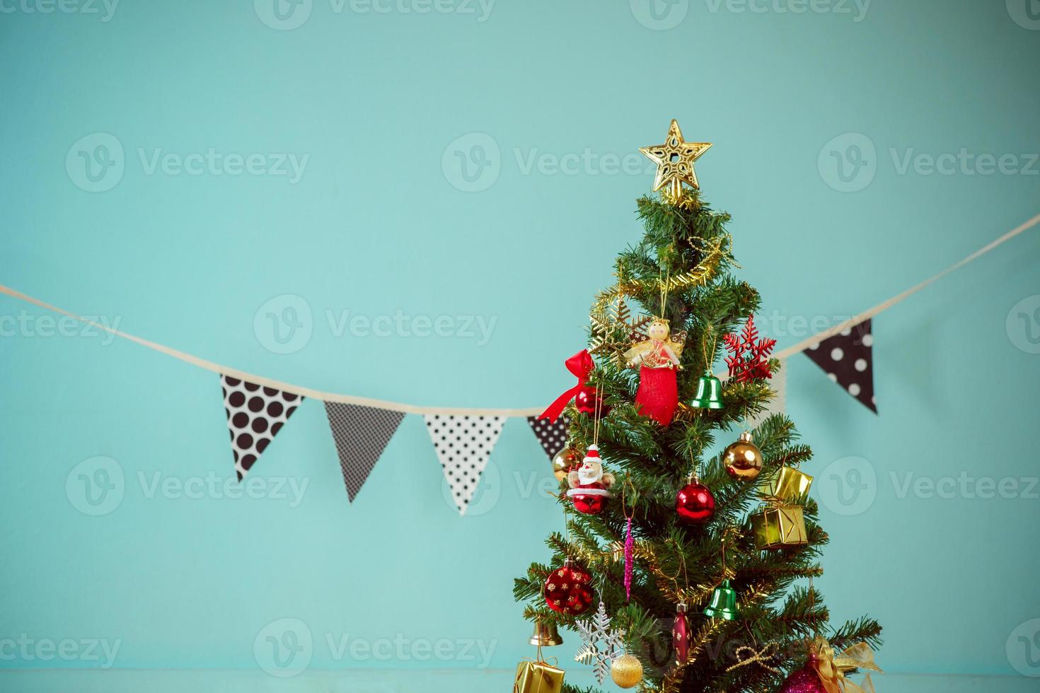 Christmas tree with gifts on green background photo