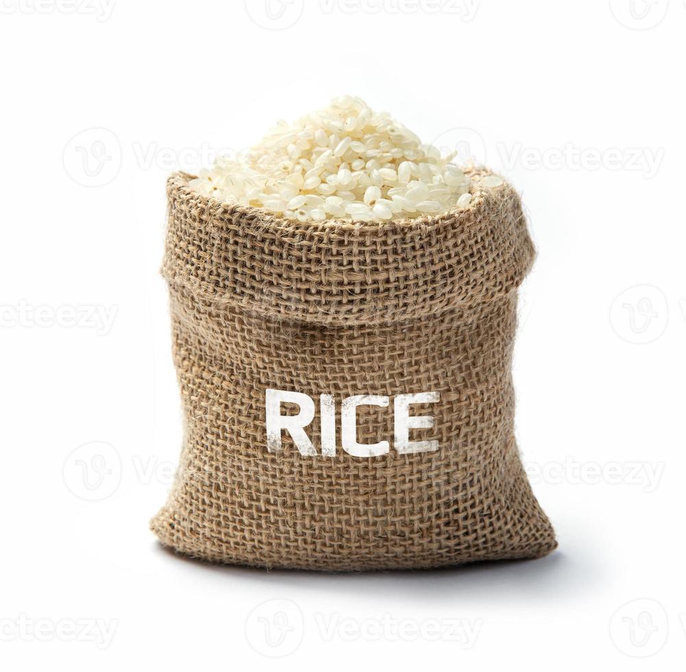 Dry rice grains in burlap photo