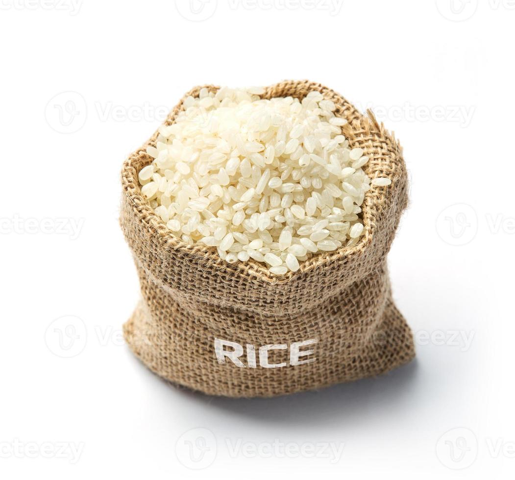 Dry rice grains in burlap photo