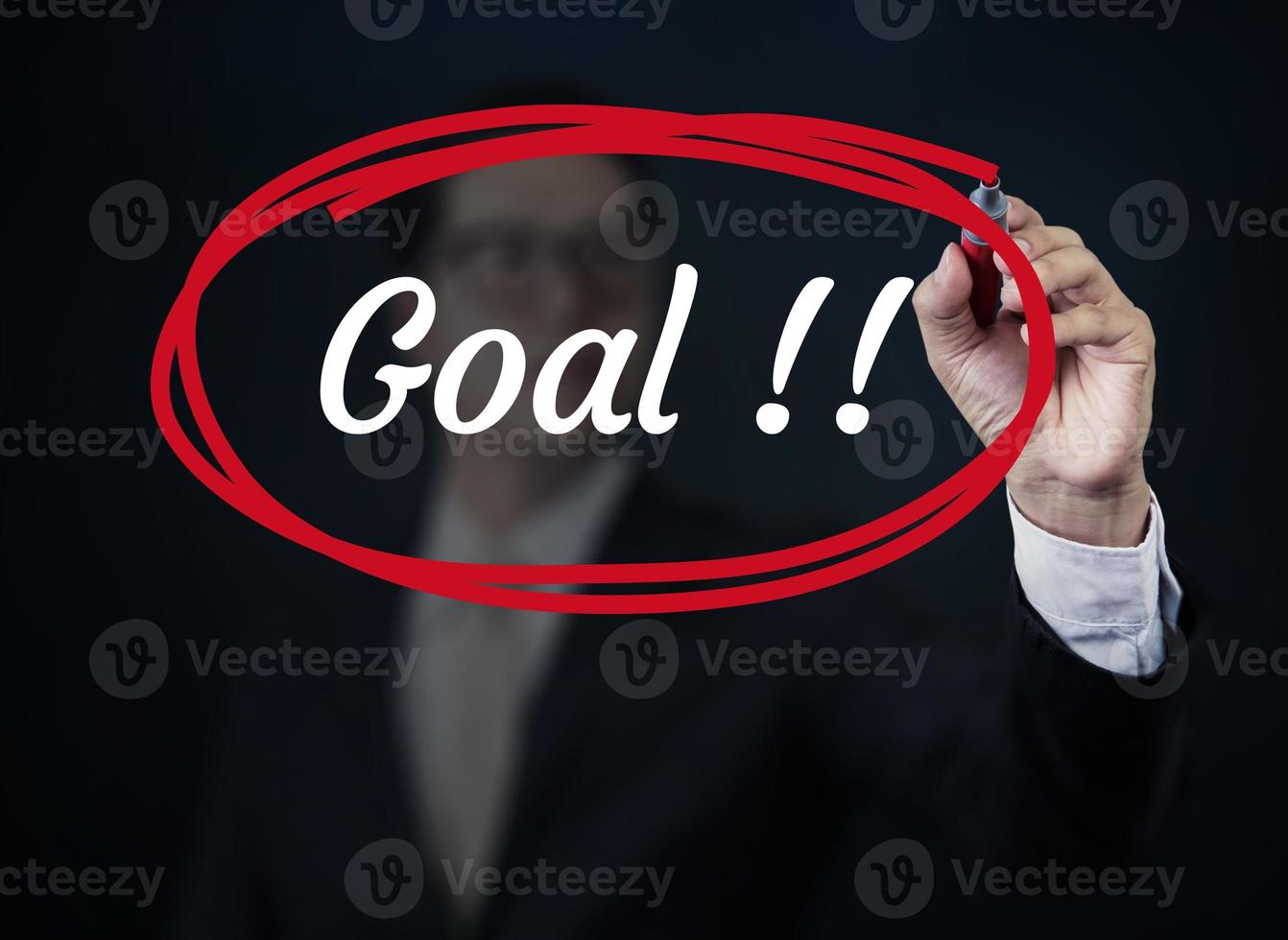 Businessman hand writing Goal with red marker on transparent board, new business concept, studio shot photo