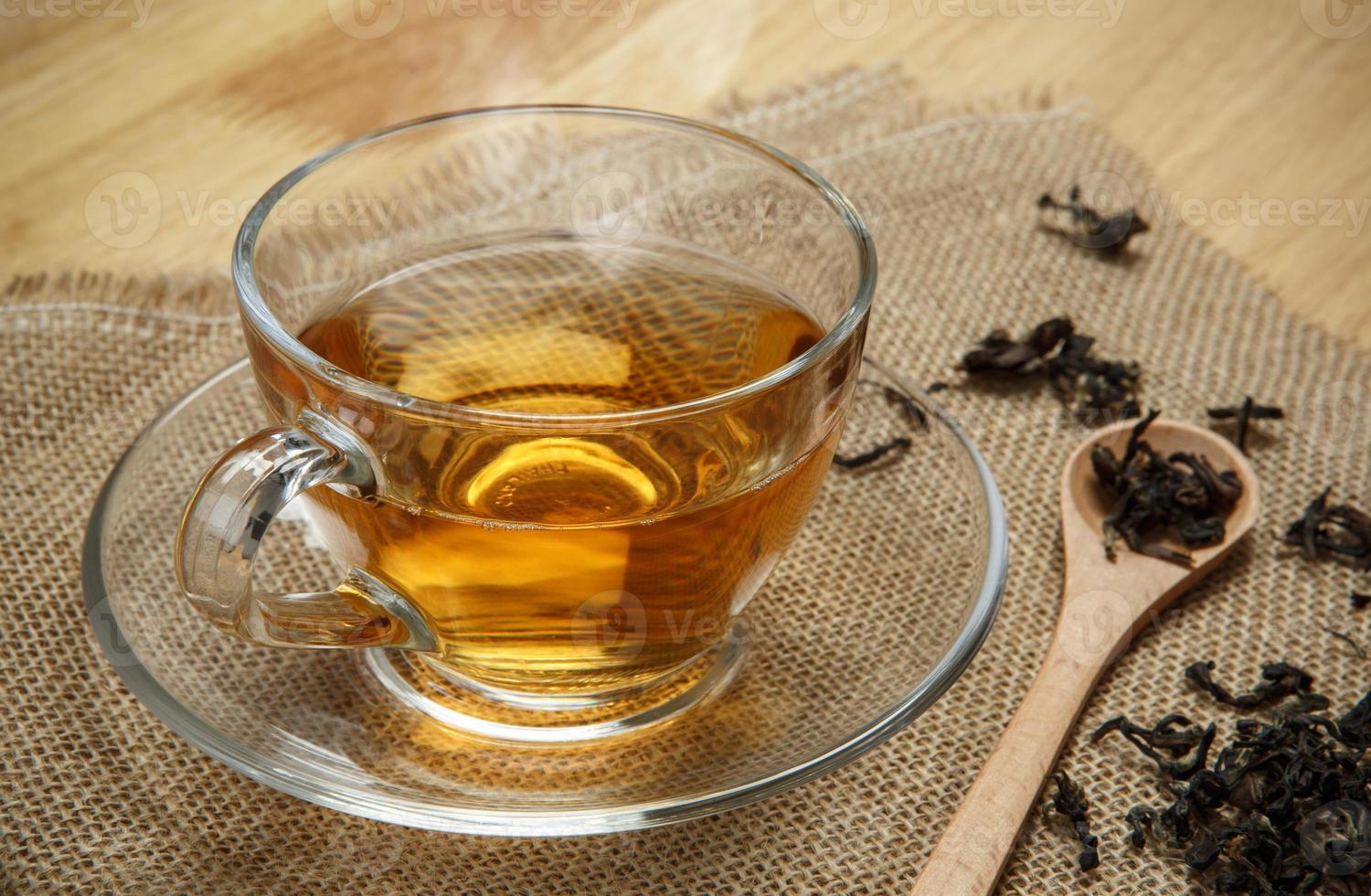 Vintage tea and leaves tea on sacking background photo