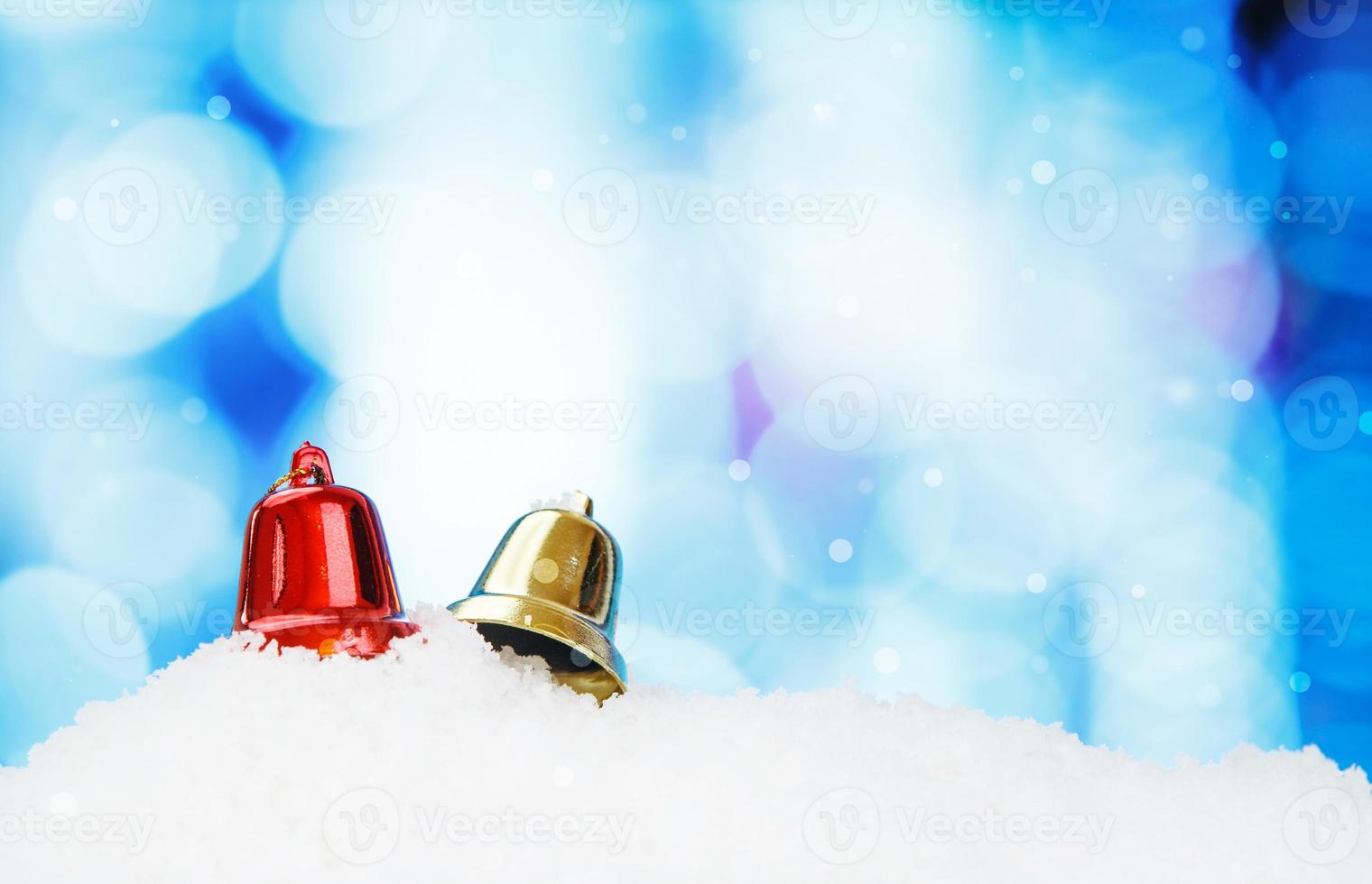 Bell and christmas decoration on abstract background and snowflakes photo