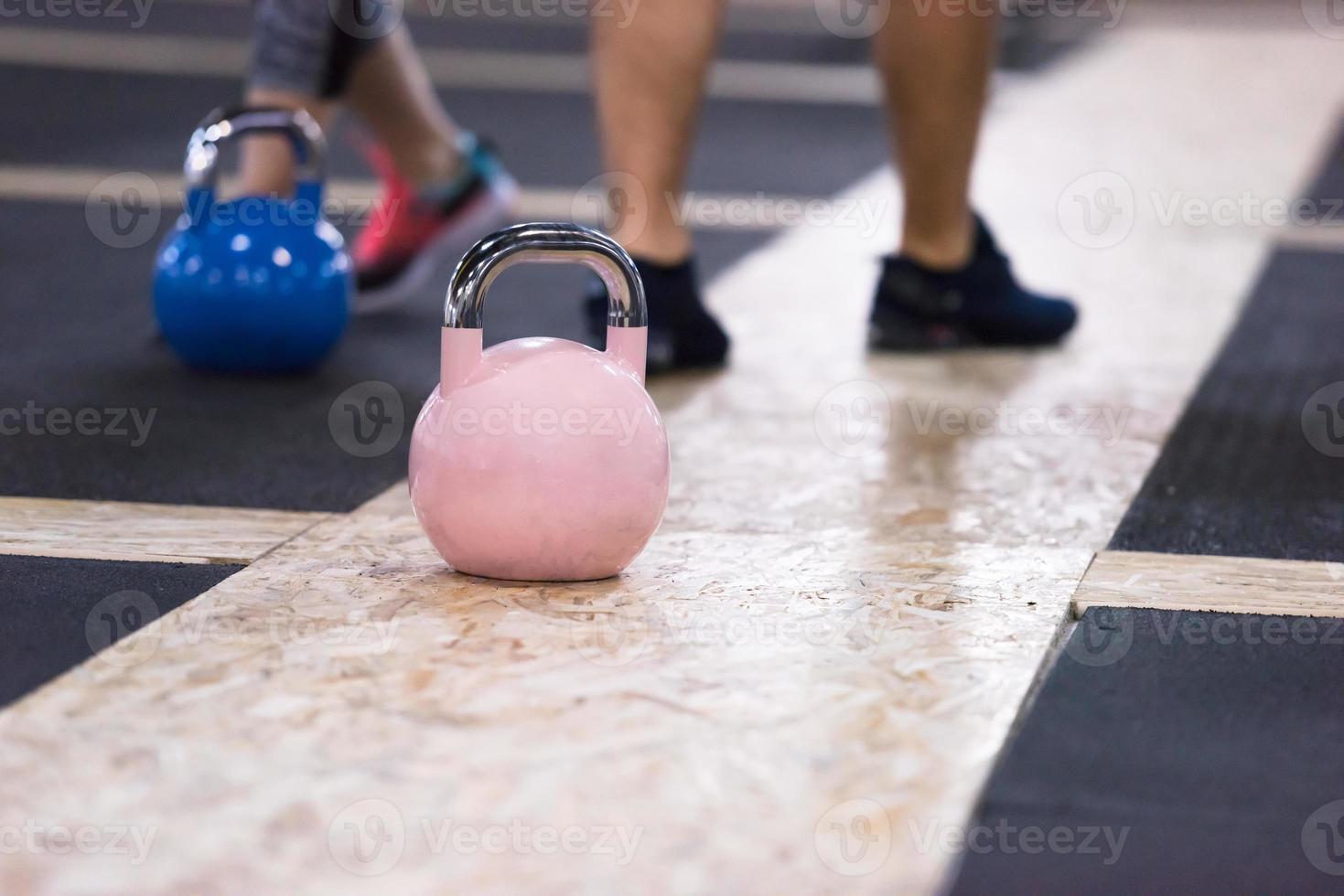 athletes doing exercises with kettlebells photo