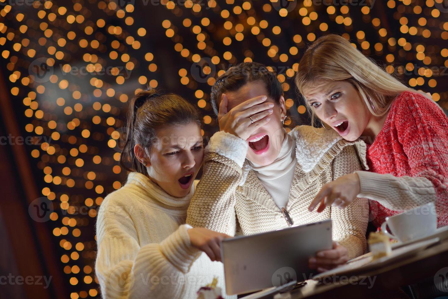 happy girls group  looking at a pc tablet photo