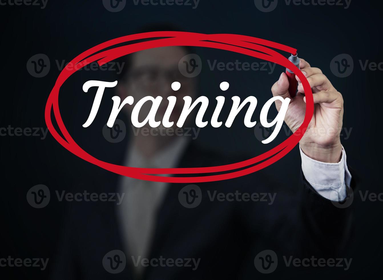 Businessman hand writing Training with red marker on transparent board, new business concept, studio shot photo