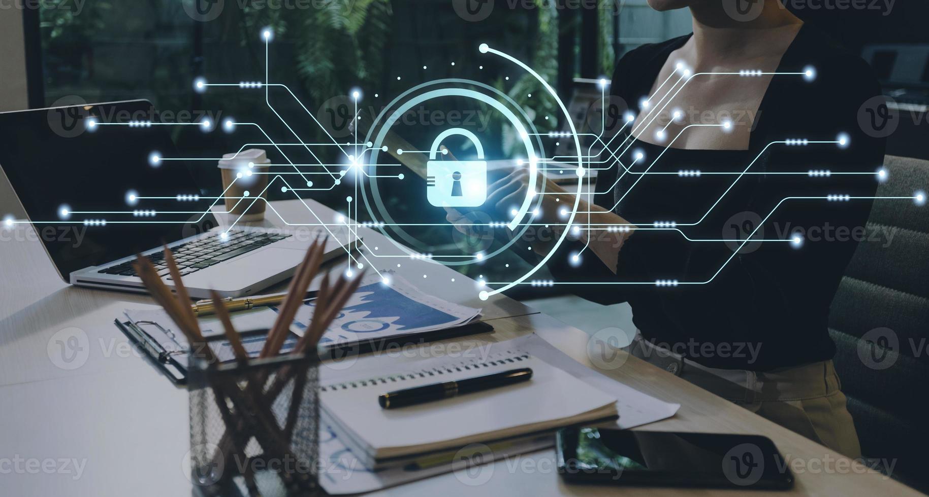 Cybersecurity and privacy concepts to protect data. Lock icon and internet network security technology. Businessman protecting personal data on smart phone with virtual screen interfaces. photo