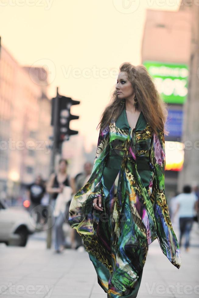 elegant woman on city street at night photo