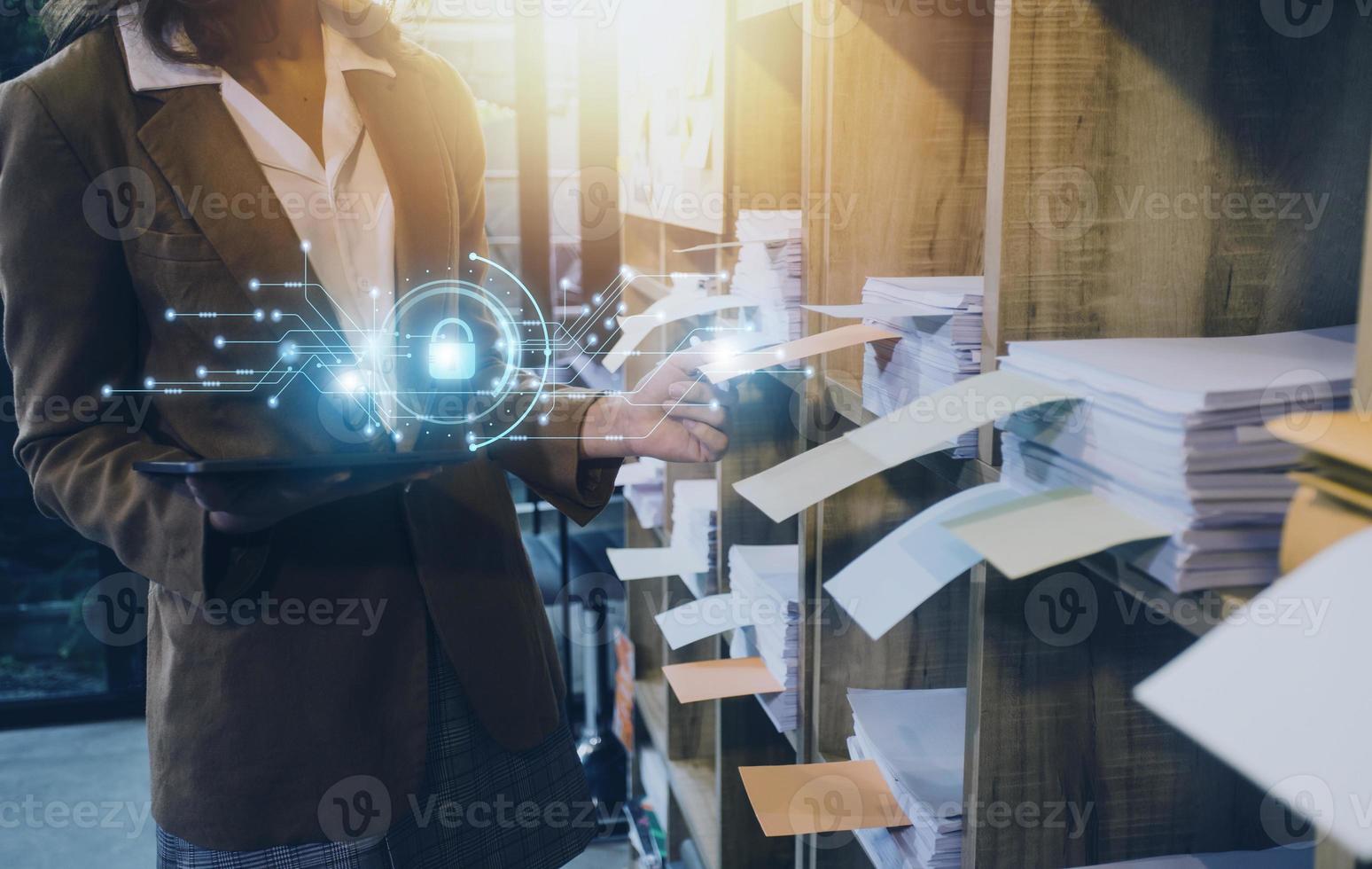 Cybersecurity and privacy concepts to protect data. Lock icon and internet network security technology. Businessman protecting personal data on smart phone with virtual screen interfaces. photo