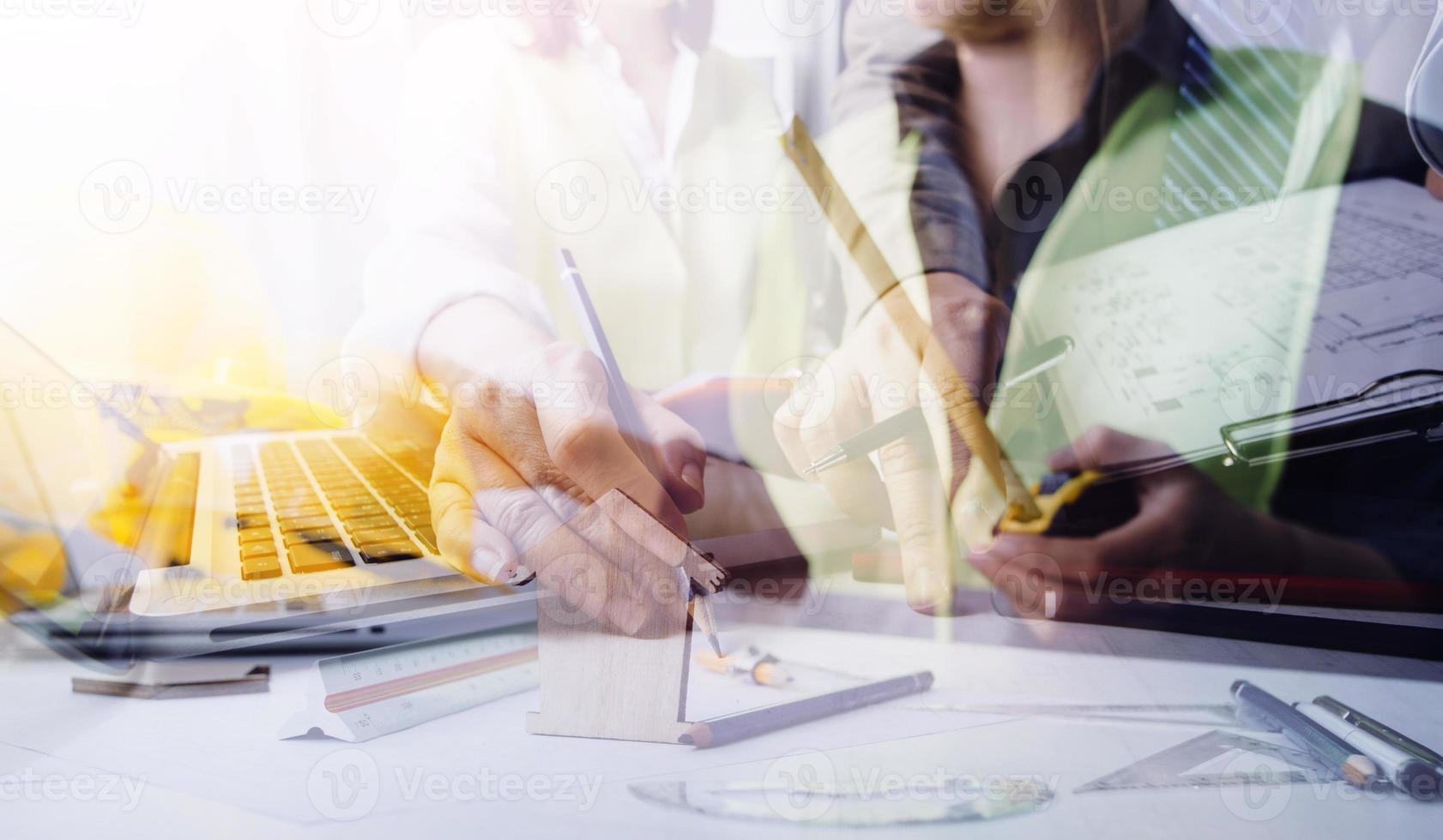 business hand working and laptop with on on architectural project at construction site at office desk in office photo