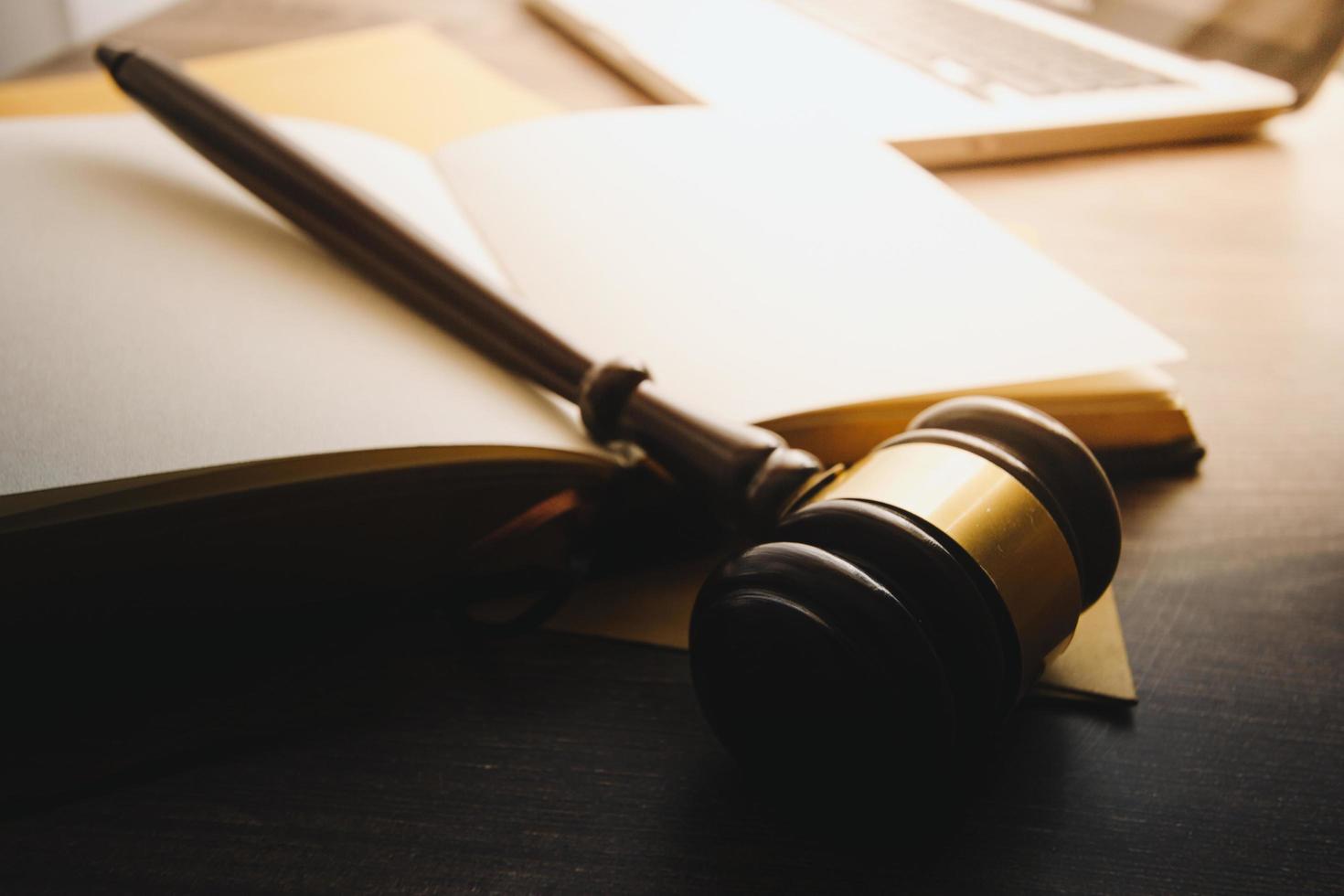 Business and lawyers discussing contract papers with brass scale on desk in office. Law, legal services, advice, justice and law concept picture with film grain effect photo