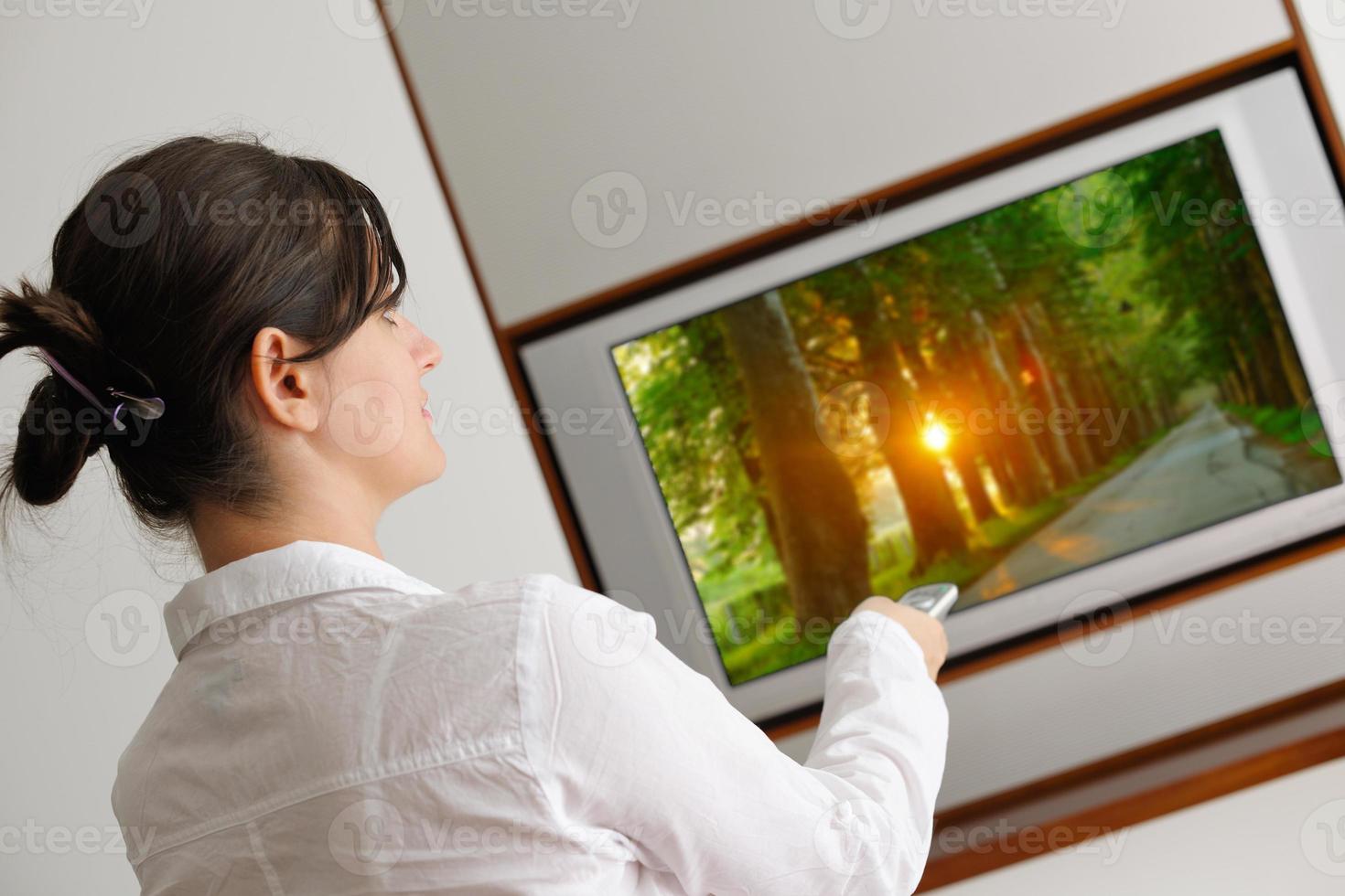 mujer joven viendo tv en casa foto